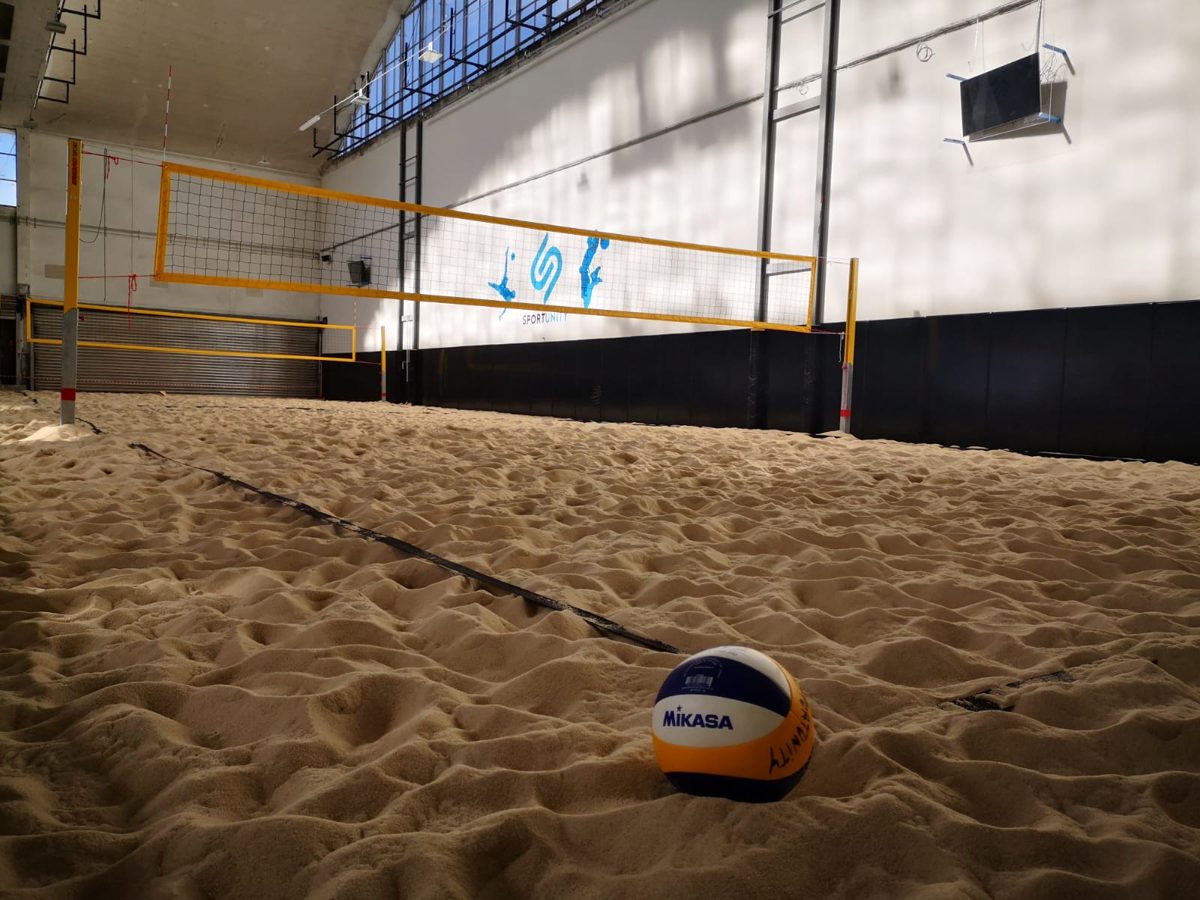 Indoor sand beach volley court at La Halle, a ball resting in the sand