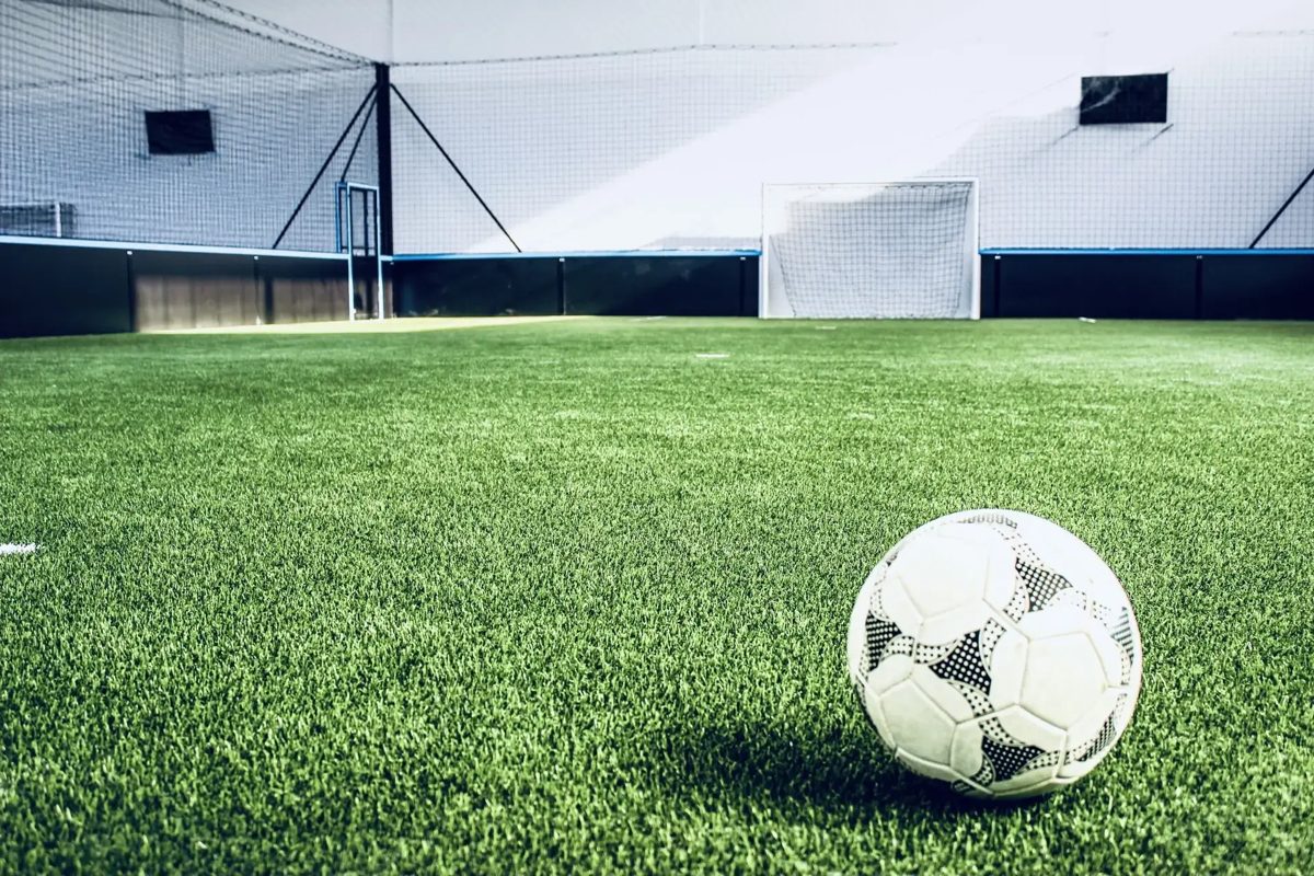 Covered synthetic football pitch with a ball