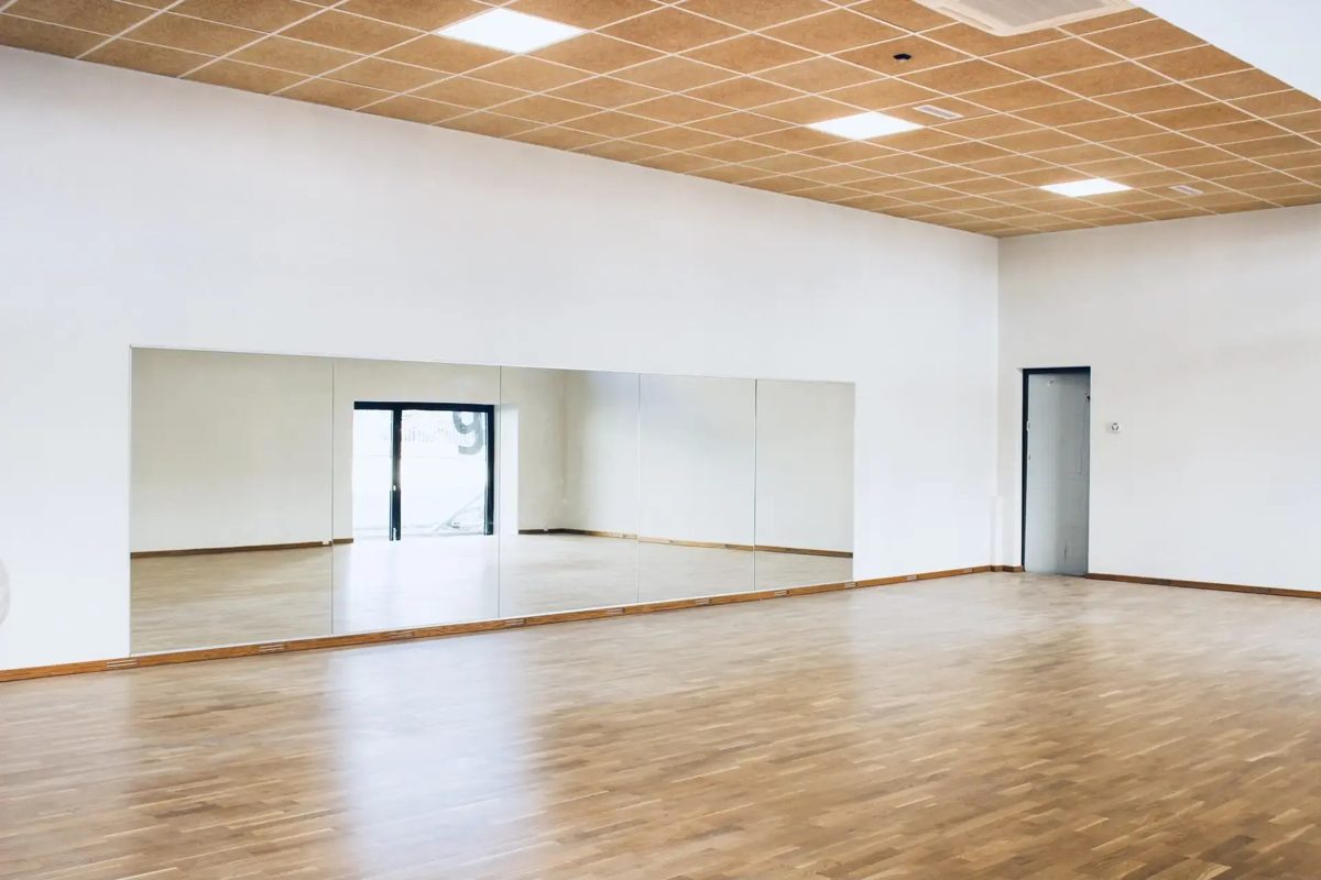 Bright studio with wooden floor and mirrors