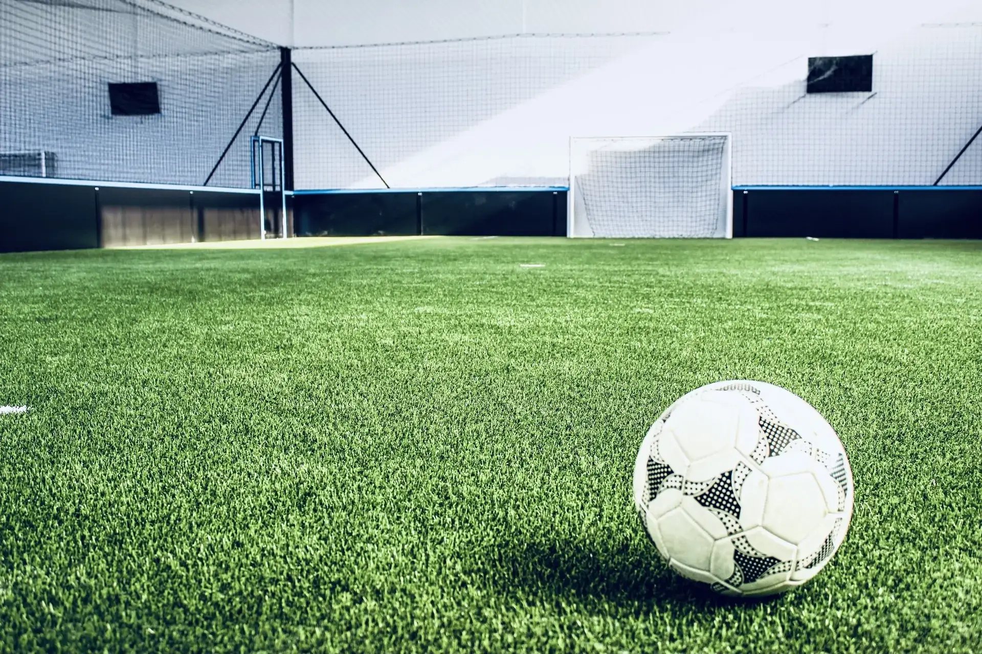 A ball on the green turf of our football pitch at La Halle